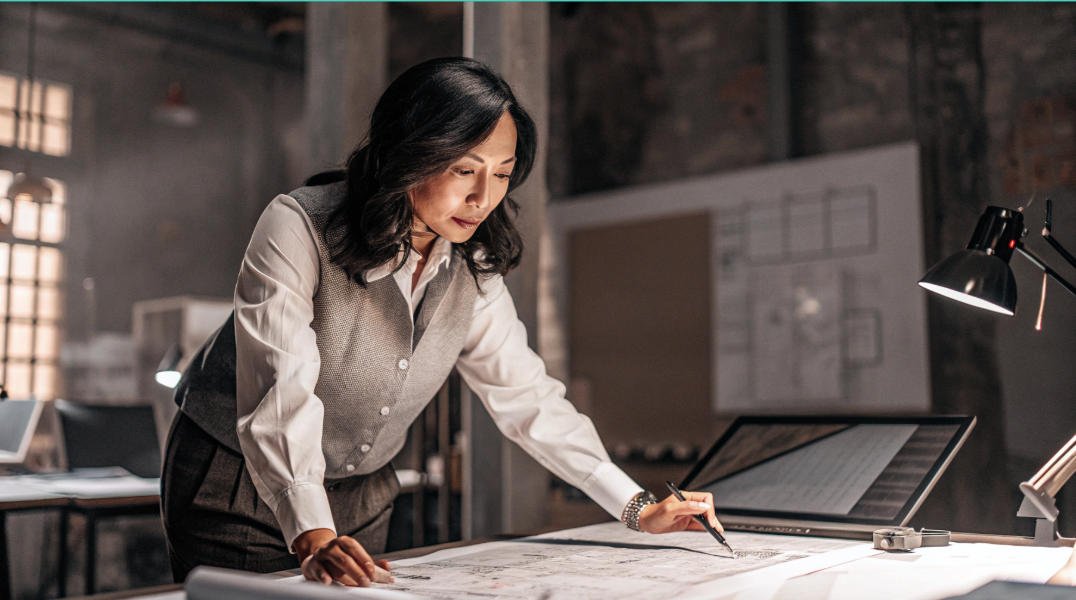 China sourcing agent in a business suit is looking at a laptop