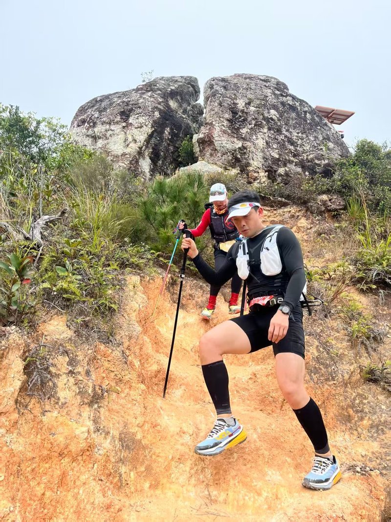 Allen on a mountain trail with poles — from half-marathons to 50 km trail races.