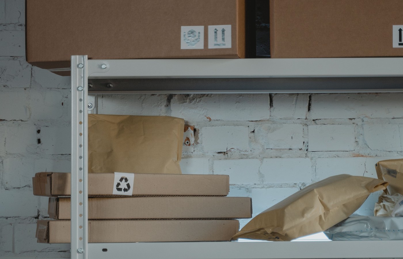 Stacked export cartons with fragile labels in a factory